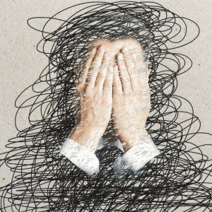 Pair of male hands held up against a face, covered in scribbles, representing mental stress.
