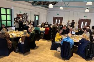 Groups of people sat around tables at a networking lunch